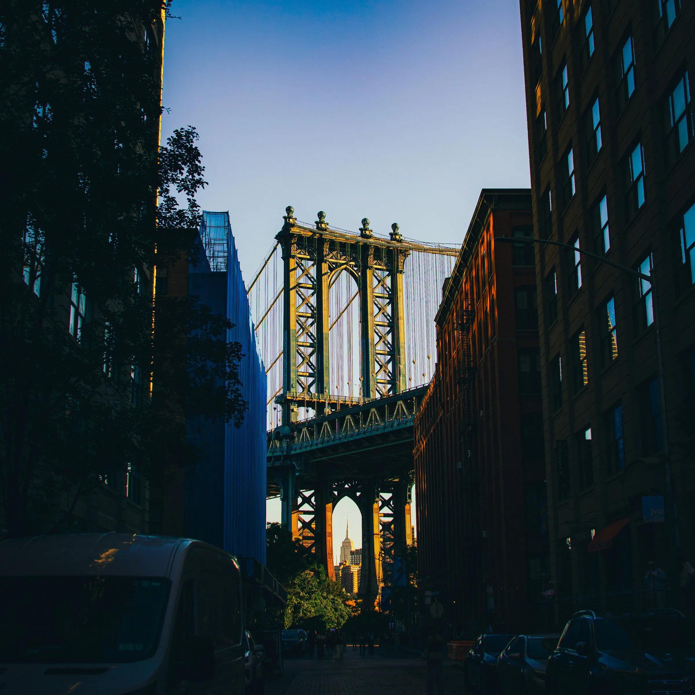 The Manhattan Bridge framing the Empire State Building at golden hour, from Washington Street in Brooklyn