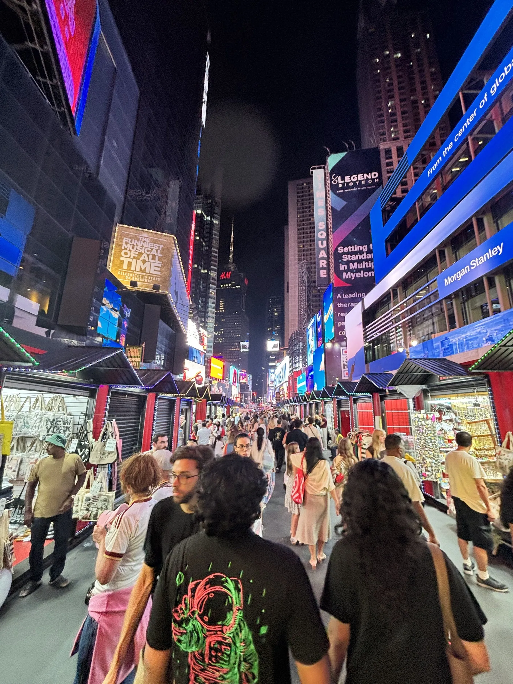 Times Square at night, crowded and lit up